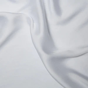 Close-up of light gray fabric with folds