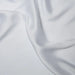 Close-up of light gray fabric with folds