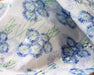 Floral patterned fabric with blue flowers on a white background