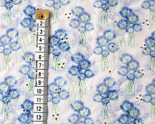 Floral patterned fabric with a ruler for scale on a white background