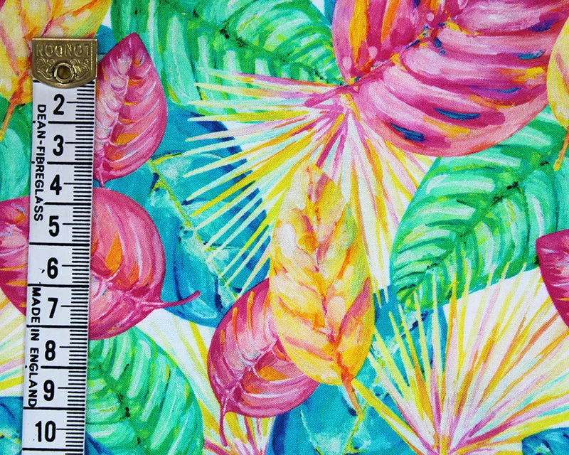 Colorful tropical leaf pattern with a ruler for scale on a multicolored background
