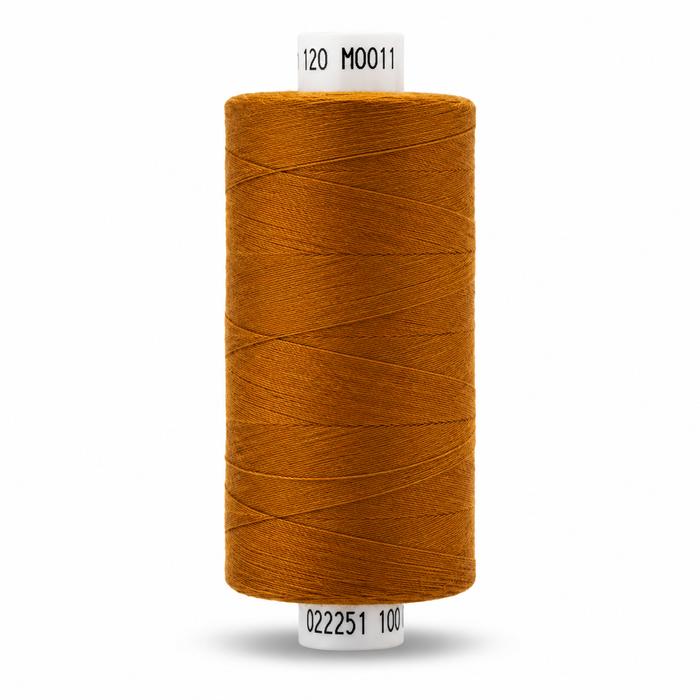 A single spool of sewing thread in a warm mustard yellow color, shown against a plain white background with black printed codes on the top and bottom labels.