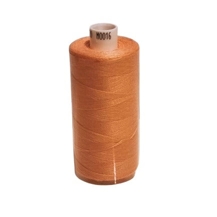 Spool of brown thread on a white background