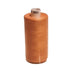 Spool of brown thread on a white background