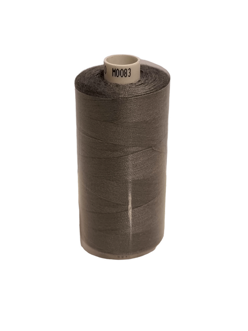 Spool of brown thread on a white background