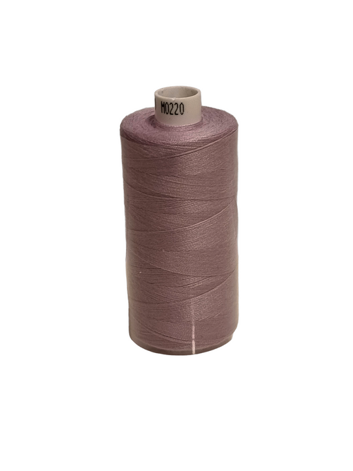 Spool of brown thread on a white background