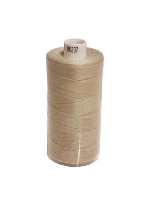 Spool of beige thread on a white background