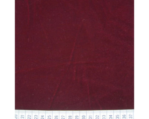 Burgundy fabric swatch with a ruler at the bottom for scale.