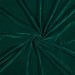 Close-up of teal green velvet fabric in a swirl pattern