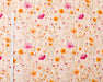 Floral patterned fabric with pink and orange flowers on a beige background, measured with a ruler.