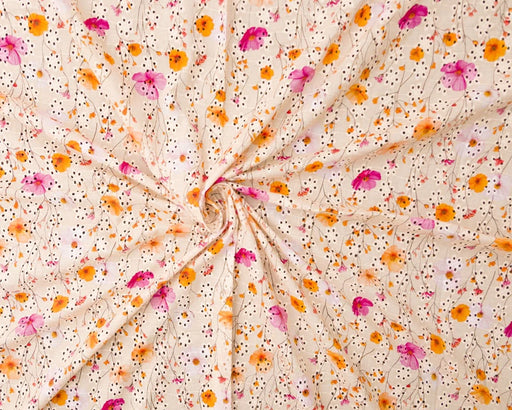 Floral fabric with pink, orange, and yellow flowers on a beige background