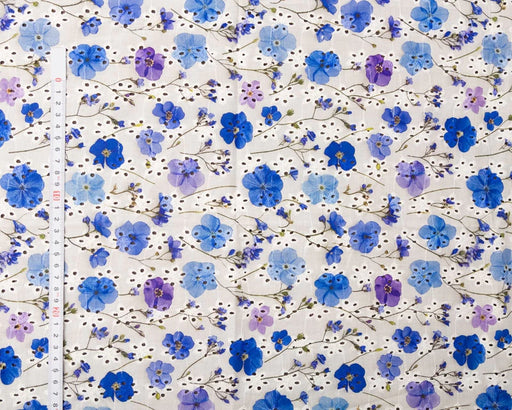Floral pattern with blue and purple flowers on a white background
