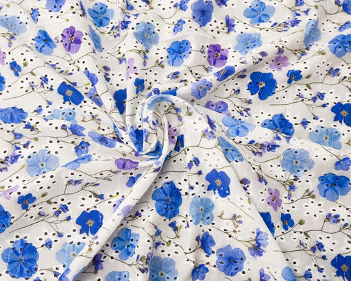 Floral fabric with blue and purple flowers on a white background