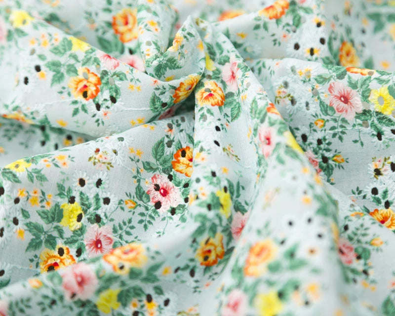 Floral fabric with colorful flowers on a light blue background