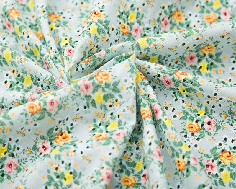 Floral fabric with small flowers on a light green background